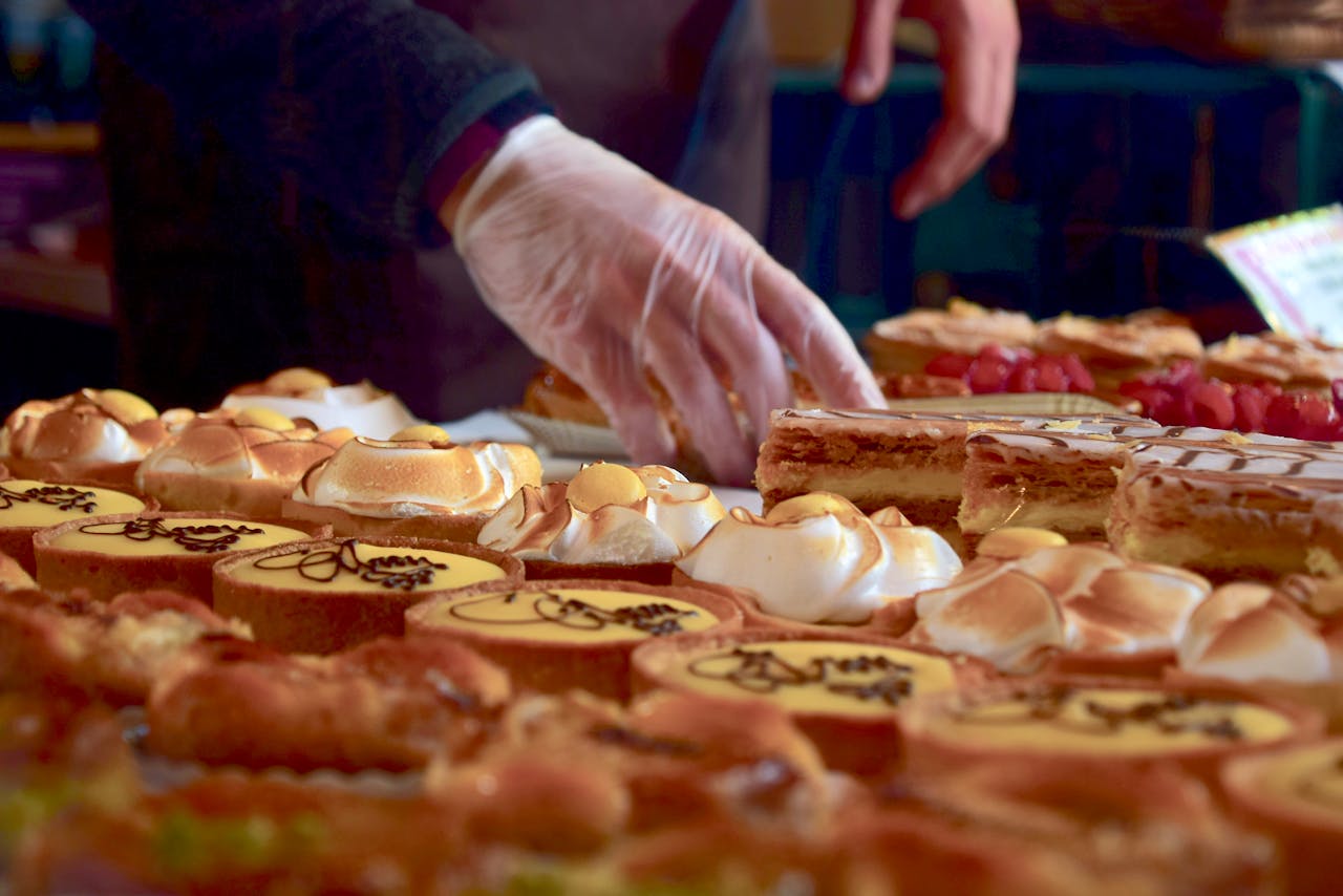 heros-img Delicious assorted pastries including custard slices and meringues at a London market stall.