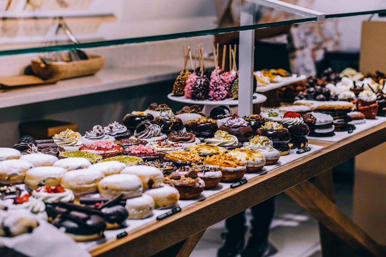 about-us A tempting display of various donuts and pastries in a bakery. Ideal for food lovers and culinary enthusiasts.